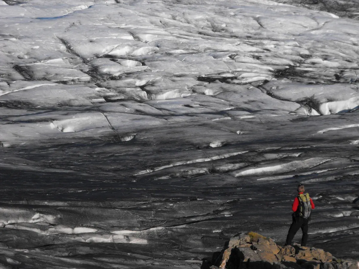 Hiker on an Icelandic glacier, as on a glacier lagoon boat tour with a hike